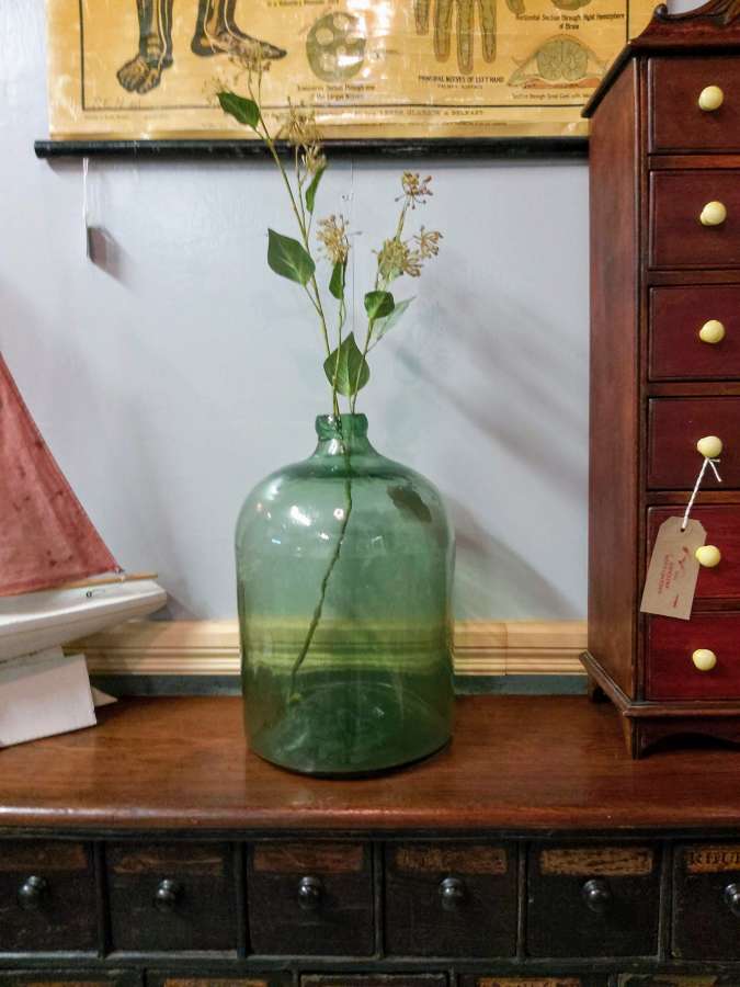 Large antique French hand blown green glass bottle