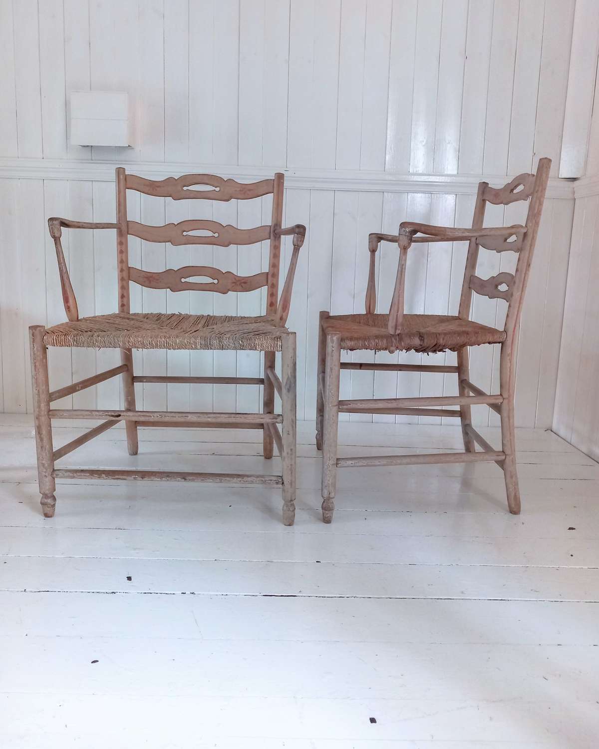 A pair of late 18th Century Thames Valley japanned 'Cottage' armchairs